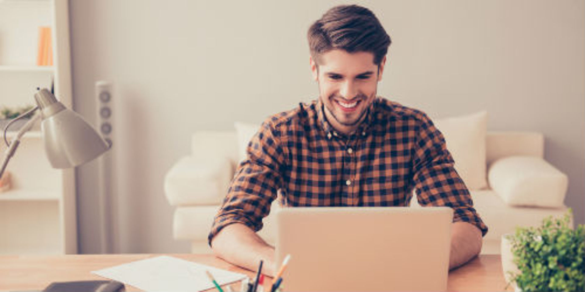 man sitting in front of the computer laughing