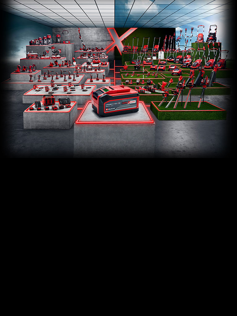 A wide range of Einhell Power X-Change tools is displayed on concrete and grass platforms. A battery is featured in the front, with numerous cordless tools and garden devices in the background. The whole scene is highlighted with modern red LED lines.