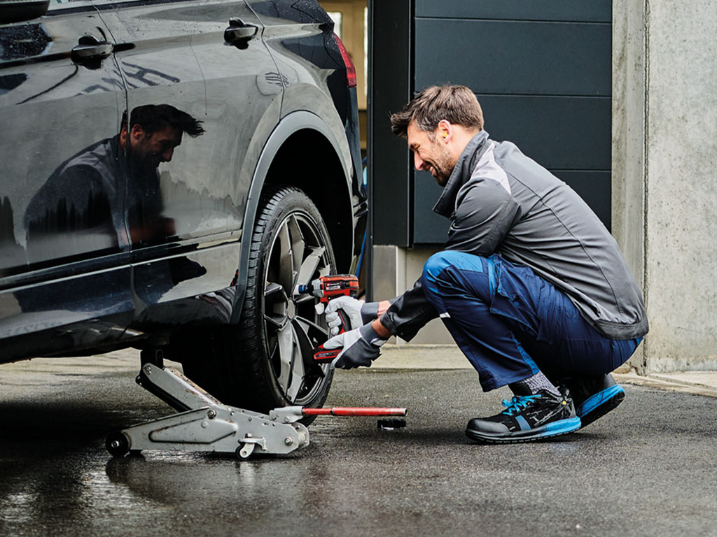 A man changing his tyres.