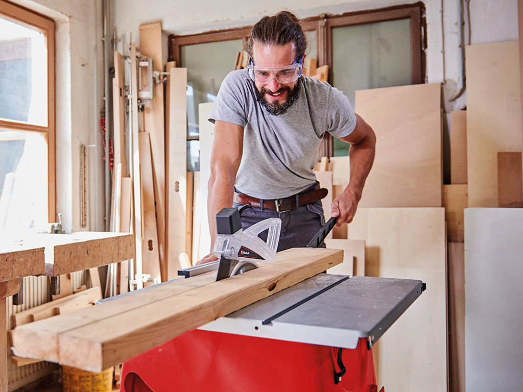 A man cuts with a table saw