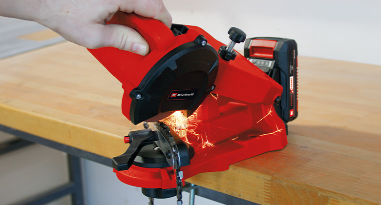 someone is sharpening a saw chain