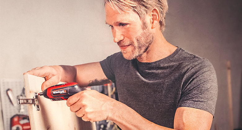man working with a cordless screwdriver