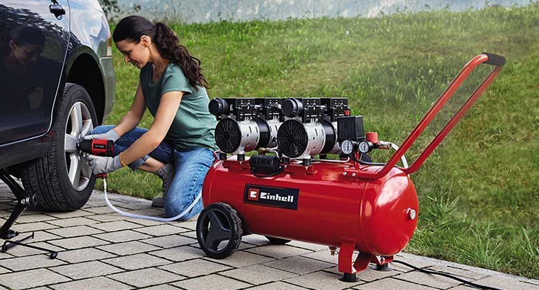 woman using an air compressor for car tyres