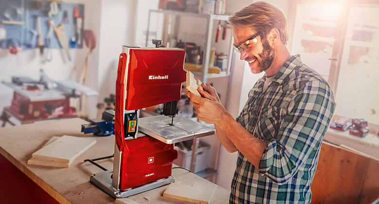 man working with a band saw