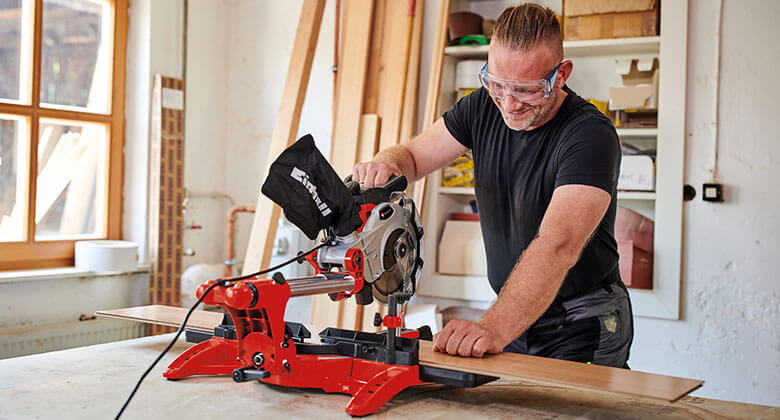 man using an electric mitre saw